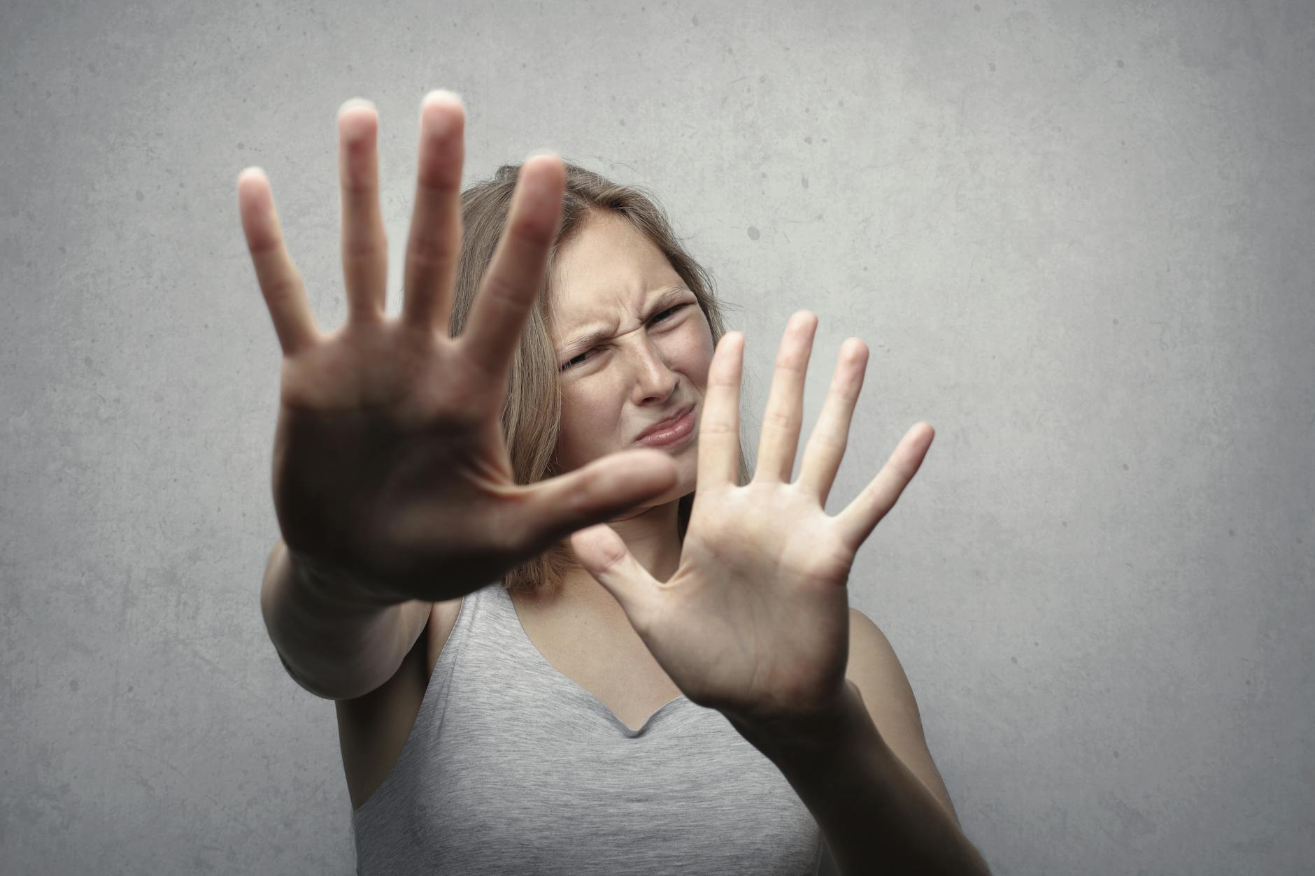 woman in gray tank top looking frightened